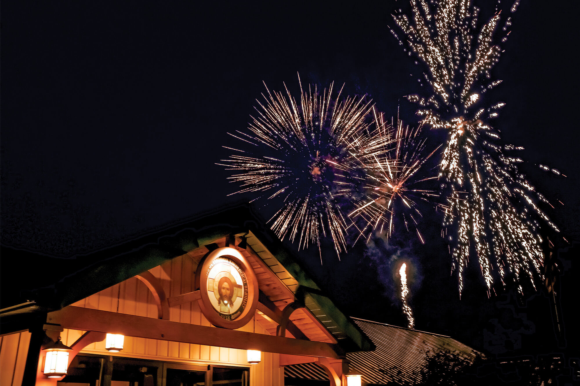 St. Tikhon's Seminary News & Media fireworks exploding over the seminary administration building at dusk.